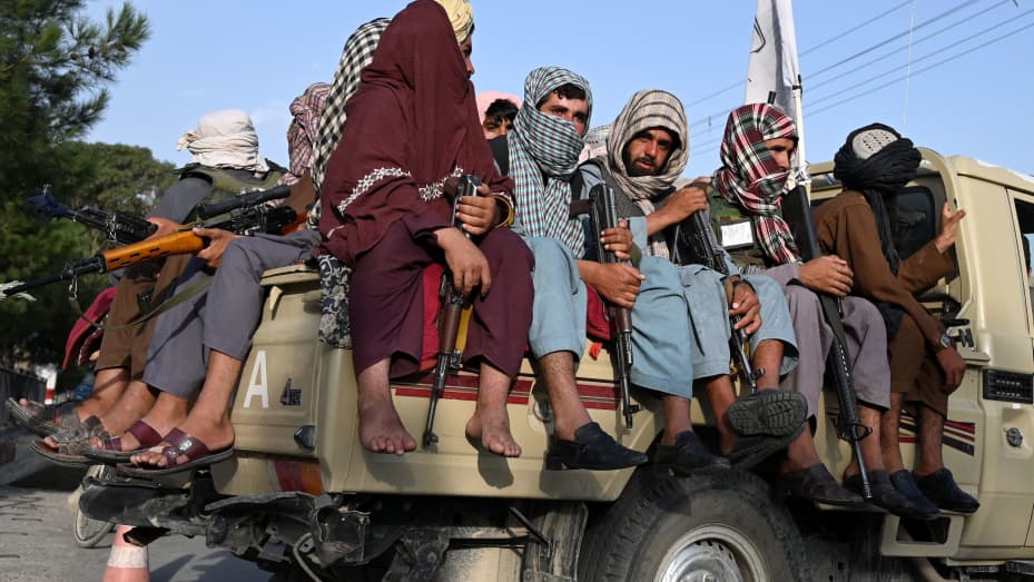 Taliban fighters in a vehicle patrol the streets of Kabul on August 23, 2021 as in the capital, the Taliban have enforced some sense of calm in a city long marred by violent crime, with their armed forces patrolling the streets and manning checkpoints.