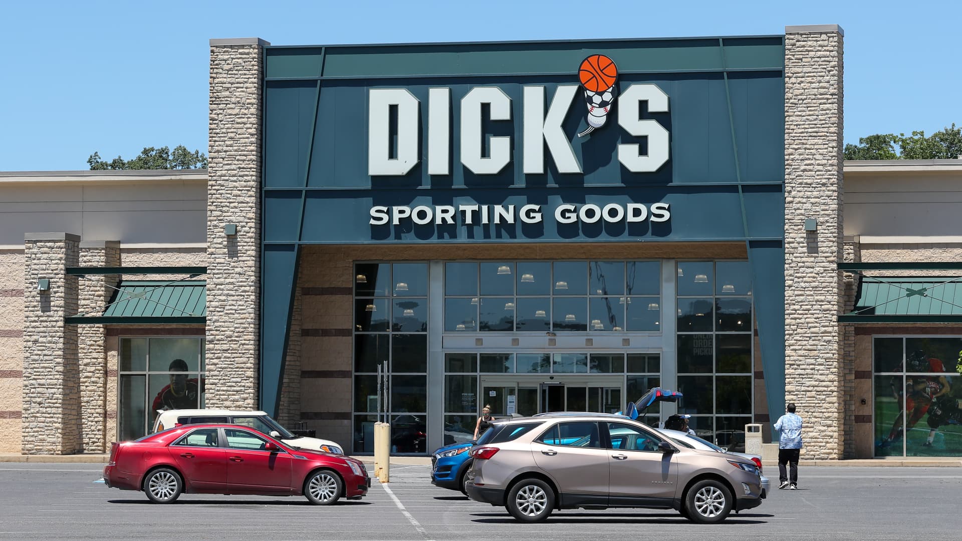 Cars are seen parked in front of a Dick's Sporting Goods store at Monroe Marketplace in Pennsylvania.