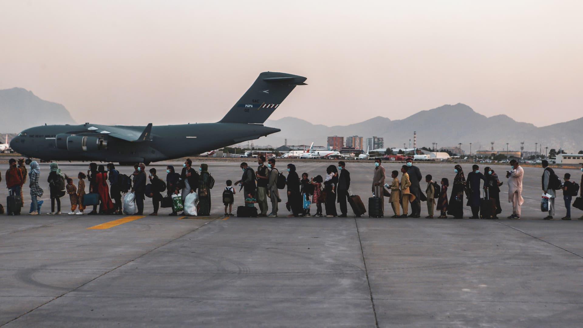 Evacuees wait to board a Boeing C-17 Globemaster III during an evacuation at Hamid Karzai International Airport in Kabul, Afghanistan, August 23, 2021.