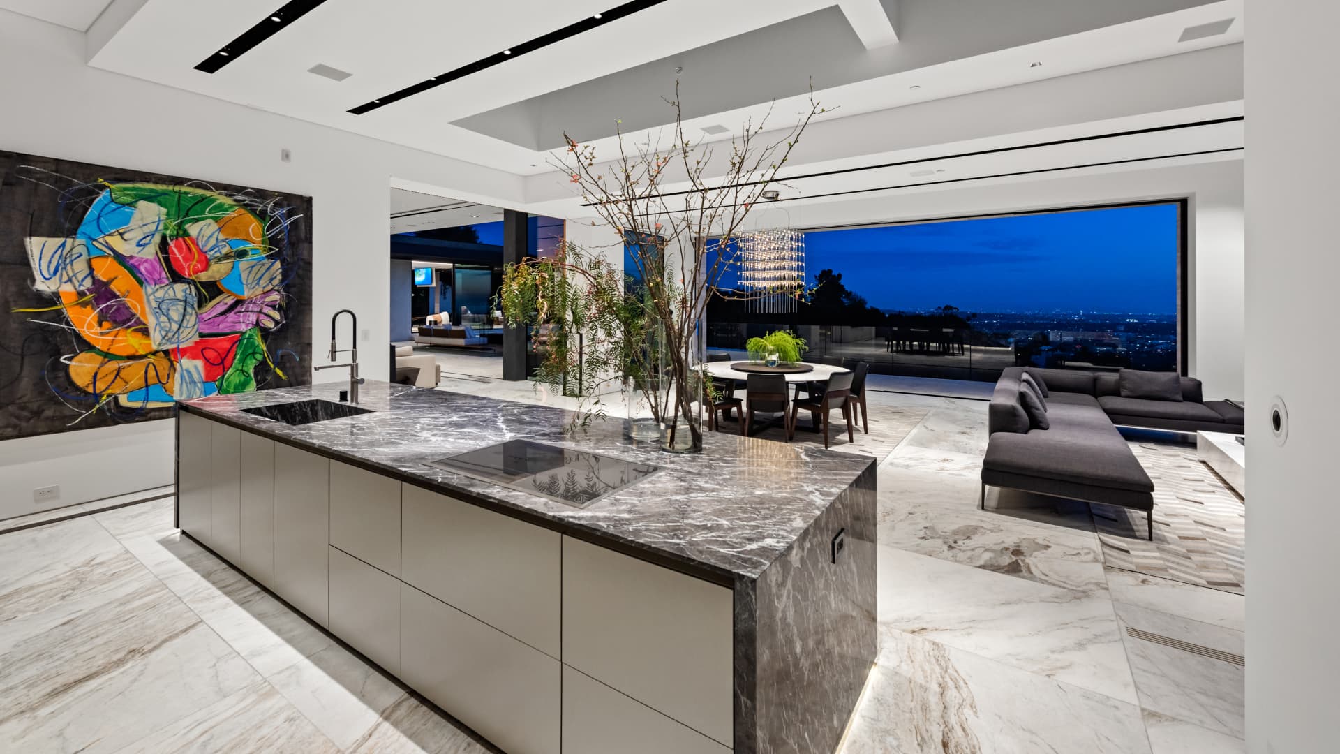 The home's main kitchen includes a 16-foot island wrapped in leathered marble.