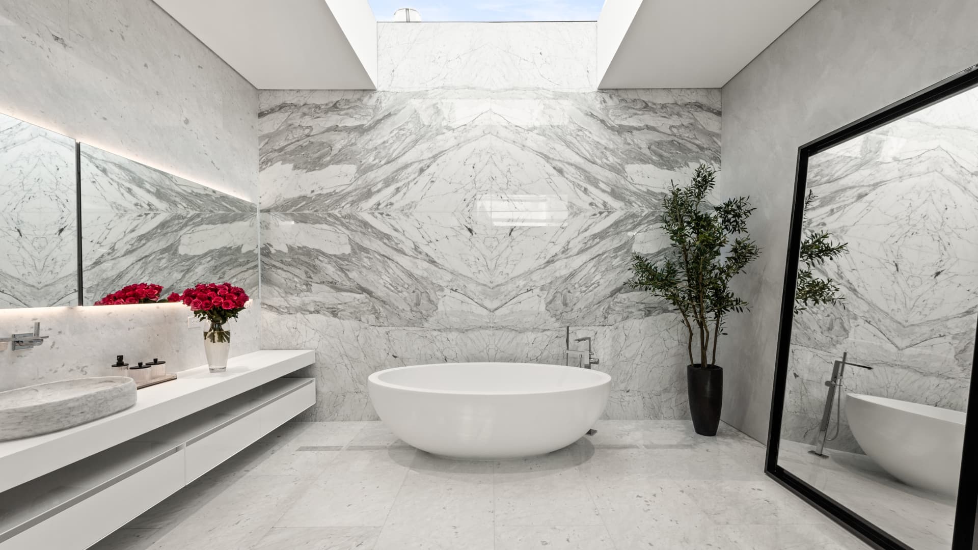 The bath in the owner's suite is clad in book-matched white marble with an oval tub.
