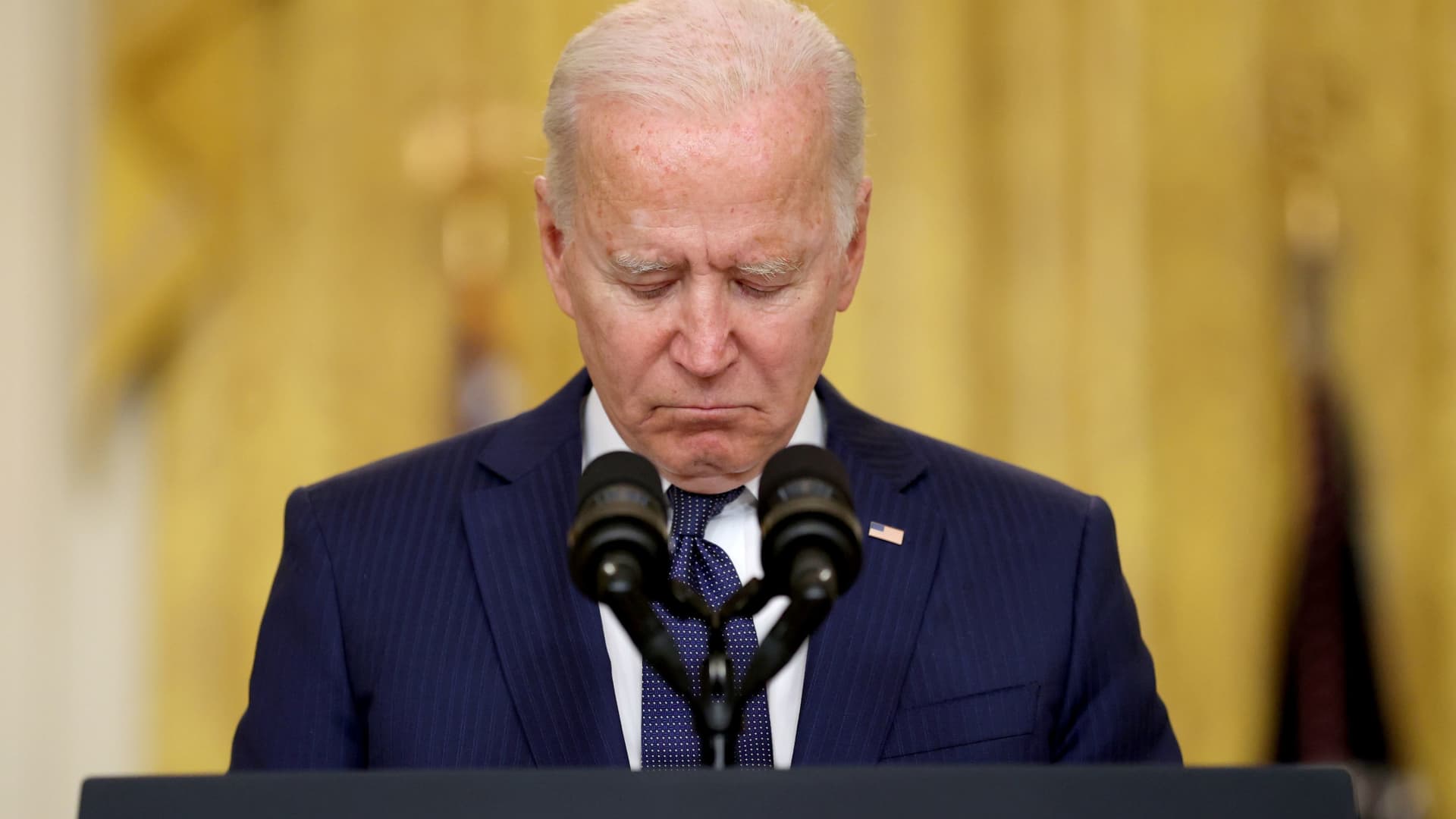 U.S. President Joe Biden reacts during a moment of silence for the dead as he delivers remarks about Afghanistan, from the East Room of the White House in Washington, August 26, 2021.