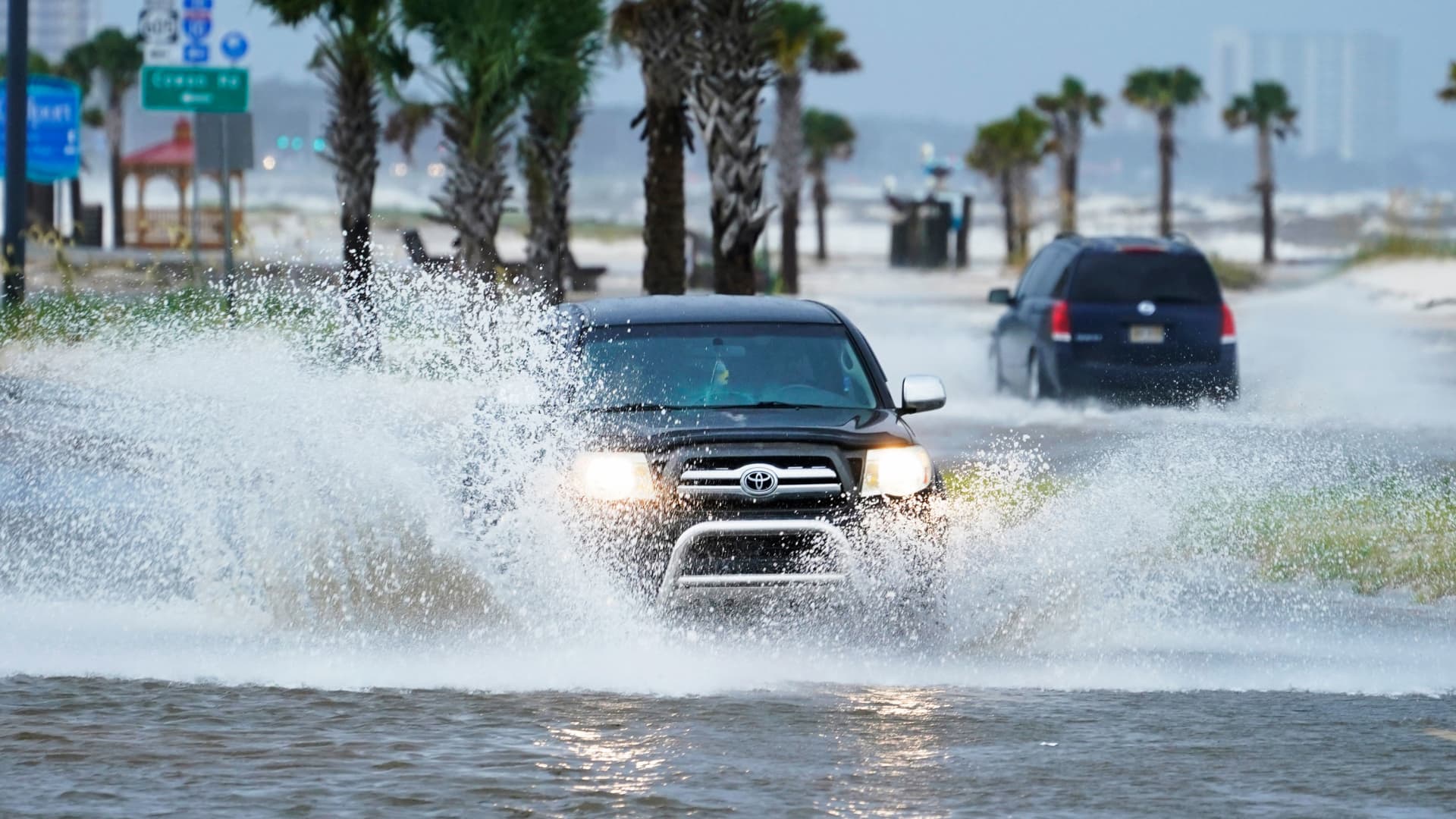 Cars drive through flood waters along route 90 as outer bands of Hurricane Ida arrive Sunday, Aug. 29, 2021, in Gulfport, Miss.