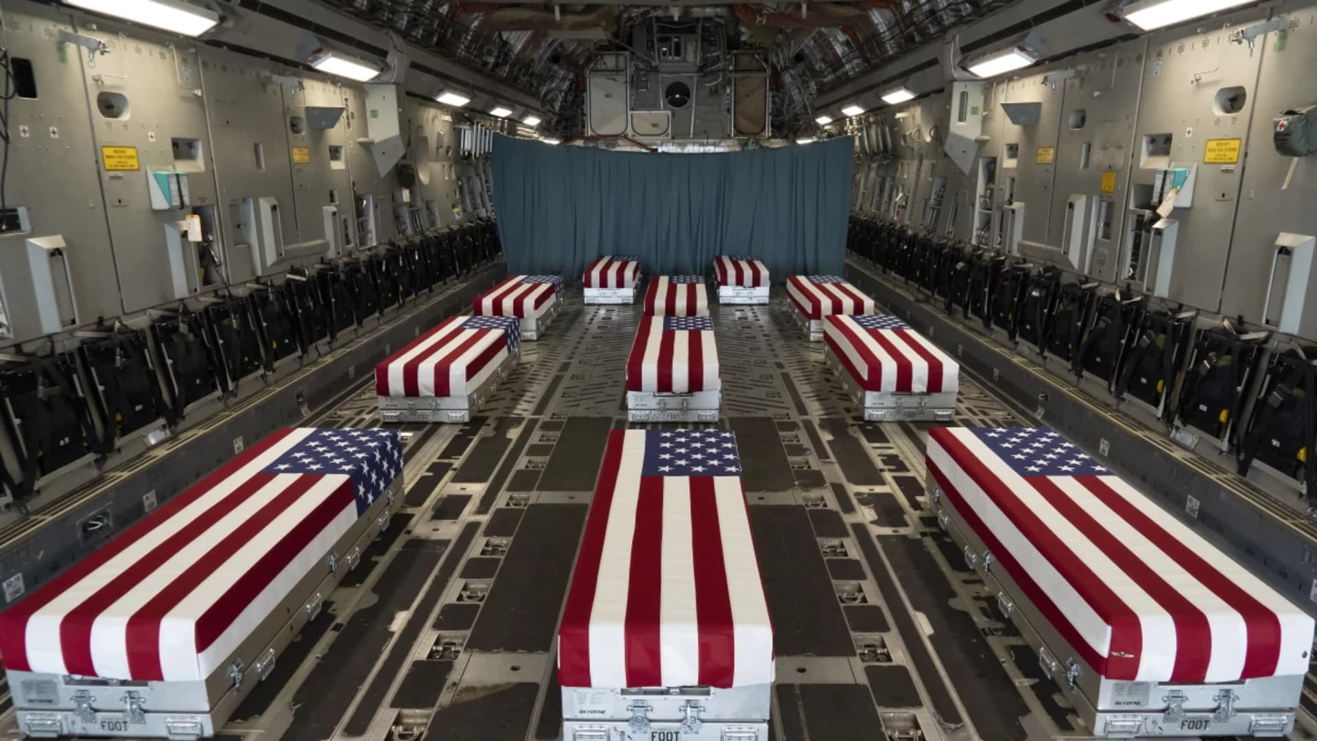 In this image provided by the U.S. Air Force, flag-draped transfer cases line the inside of a transport plane Sunday before a dignified transfer at Dover Air Force Base, Del. The fallen service members were killed while supporting evacuations in Kabul, Afghanistan.