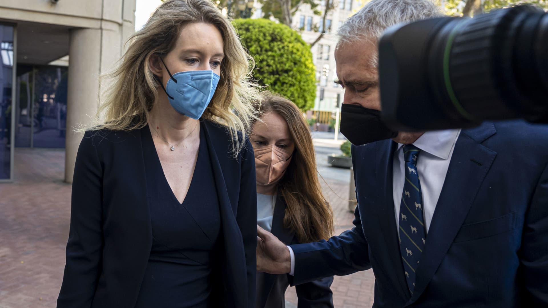 Elizabeth Holmes, founder of Theranos Inc., left, arrives at federal court in San Jose, California, on Tuesday, Aug. 31, 2021.