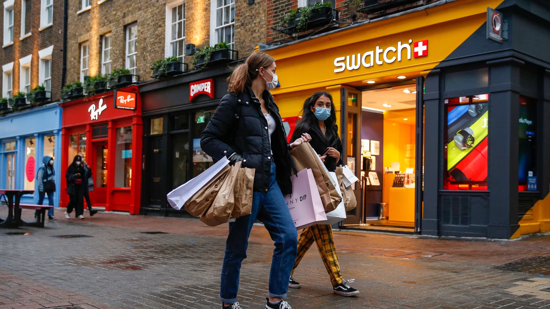 Shoppers pass a Swatch Group AG watch store in London, U.K., on Wednesday, Oct. 21, 2020.
