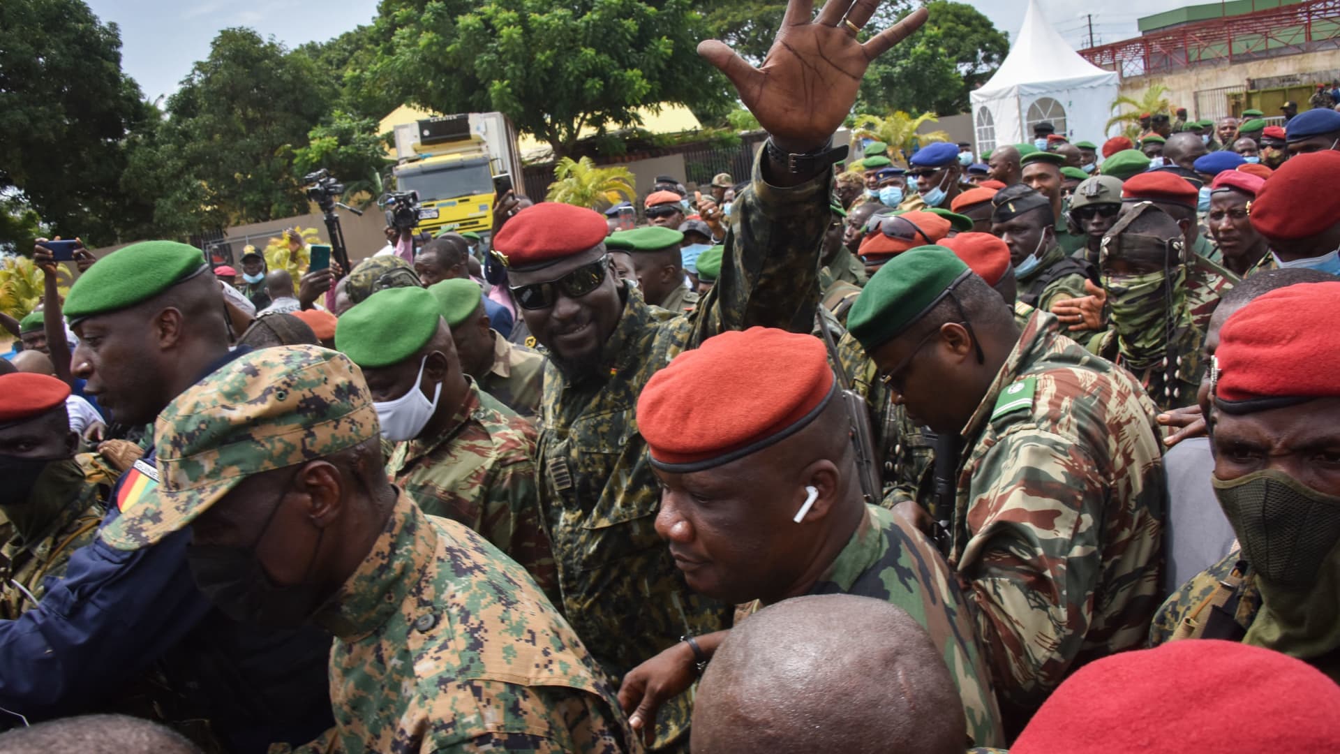 CONAKRY, Guinea - Lieutenant Colonel Mamady Doumbouya, head of the army's special forces and coup leader, waves to the crowd as he arrives at the Palace of the People in Conakry on September 6, 2021, ahead of a meeting with the Ministers of the Ex-President of Guinea, Alpha Conde.