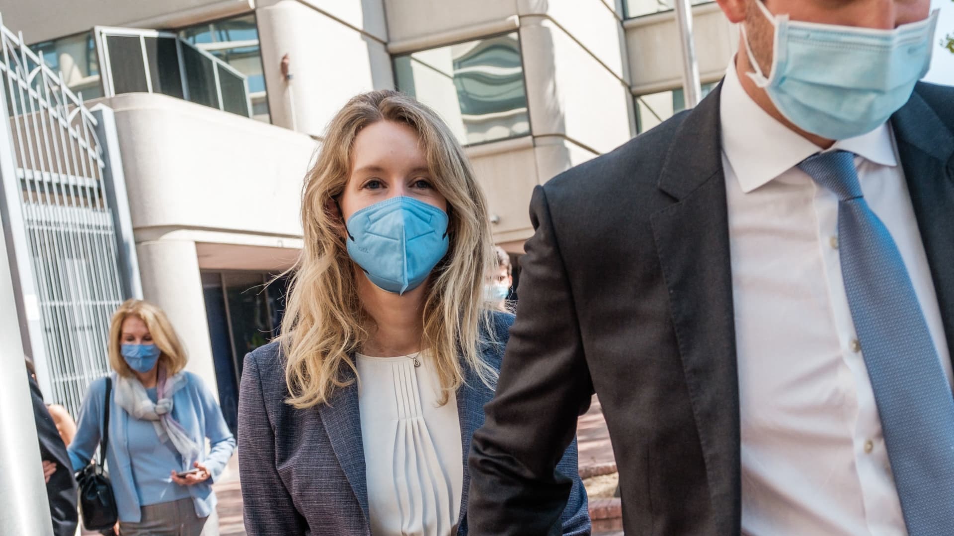 Elizabeth Holmes (L), founder and former CEO of Theranos, leaves the courthouse with her husband Billy Evans after the first day of her fraud trial in San Jose on Sept. 8, 2021.