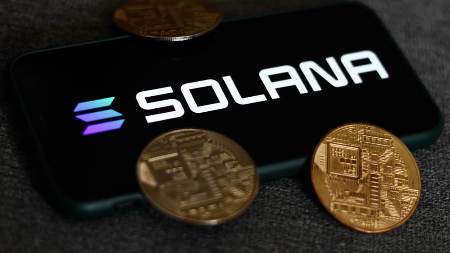Solana logo displayed on a phone screen and representation of cryptocurrencies are seen in this illustration photo taken in Krakow, Poland on August 21, 2021.