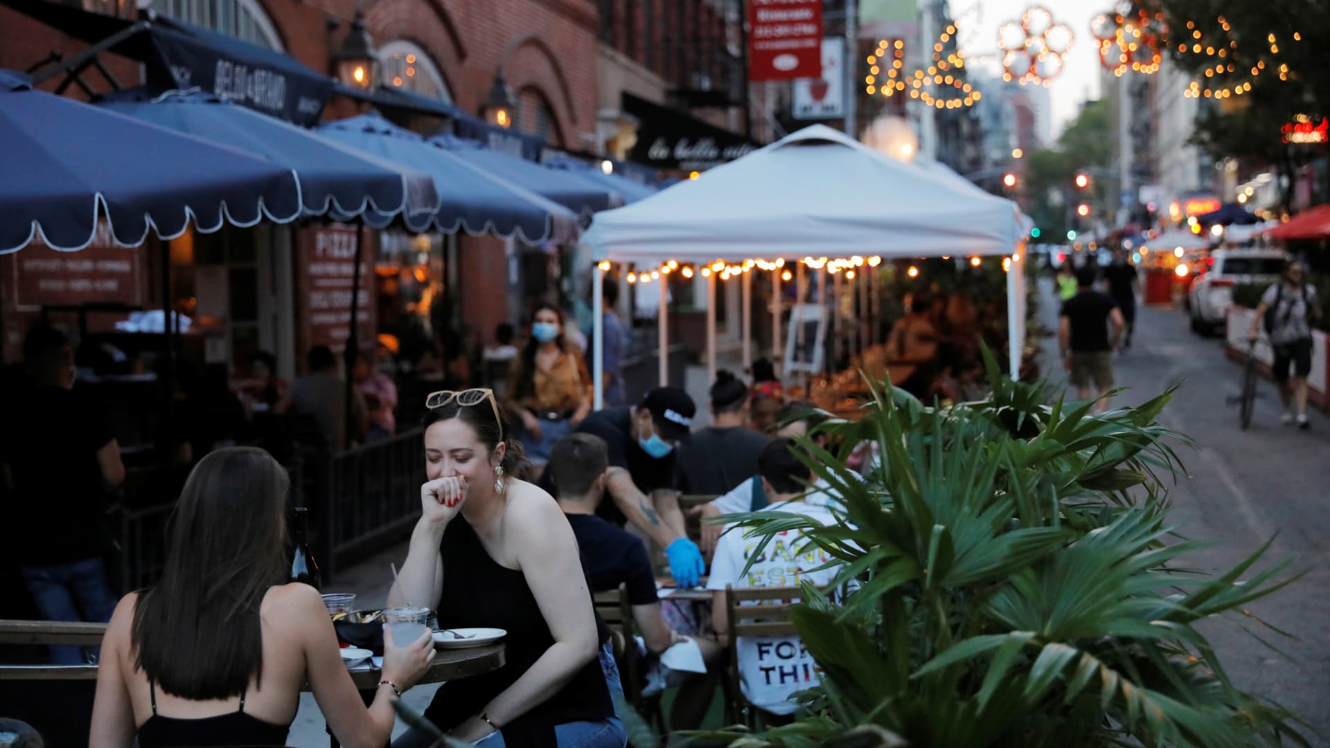 People sit at restaurant's outdoor patios in Manhattan, New York City, August 14, 2020.