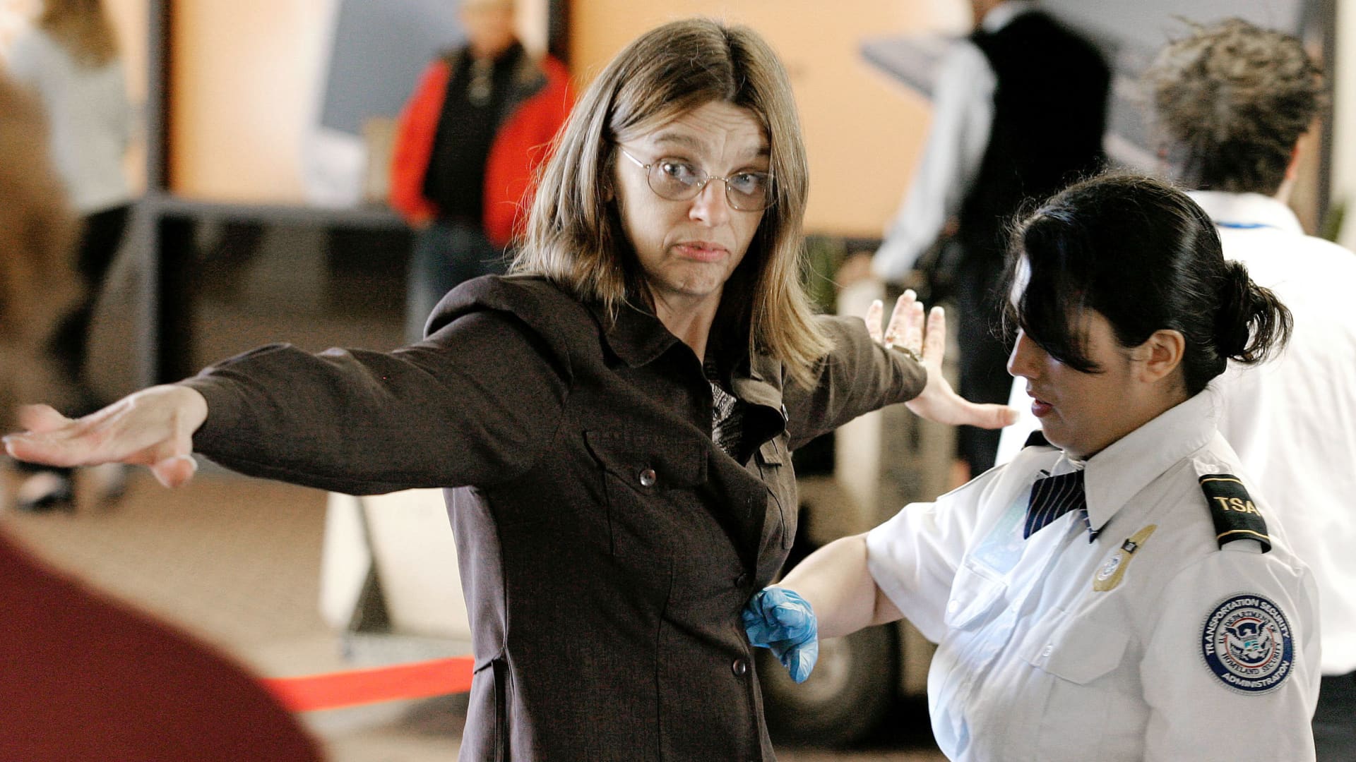 A Transportation Security Administration agent performs a pat-down check on an airline passenger at a security checkpoint in terminal four at Phoenix Sky Harbor International Airport December 10, 2004 in Phoenix, Arizona.