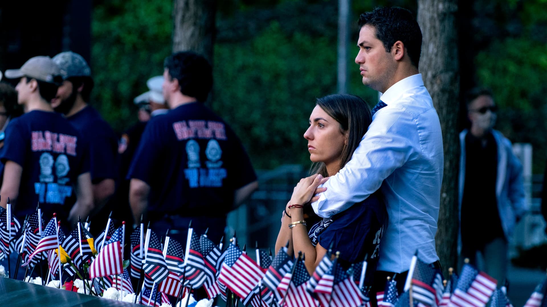 Katie Mascali is comforted by her fiance Andre Jabban as they stand near the name of her father Joseph Mascali, with FDNY Rescue 5, as they attend ceremonies on September 11, 2021, marking the attacks on the World Trade Center in Manhattan.