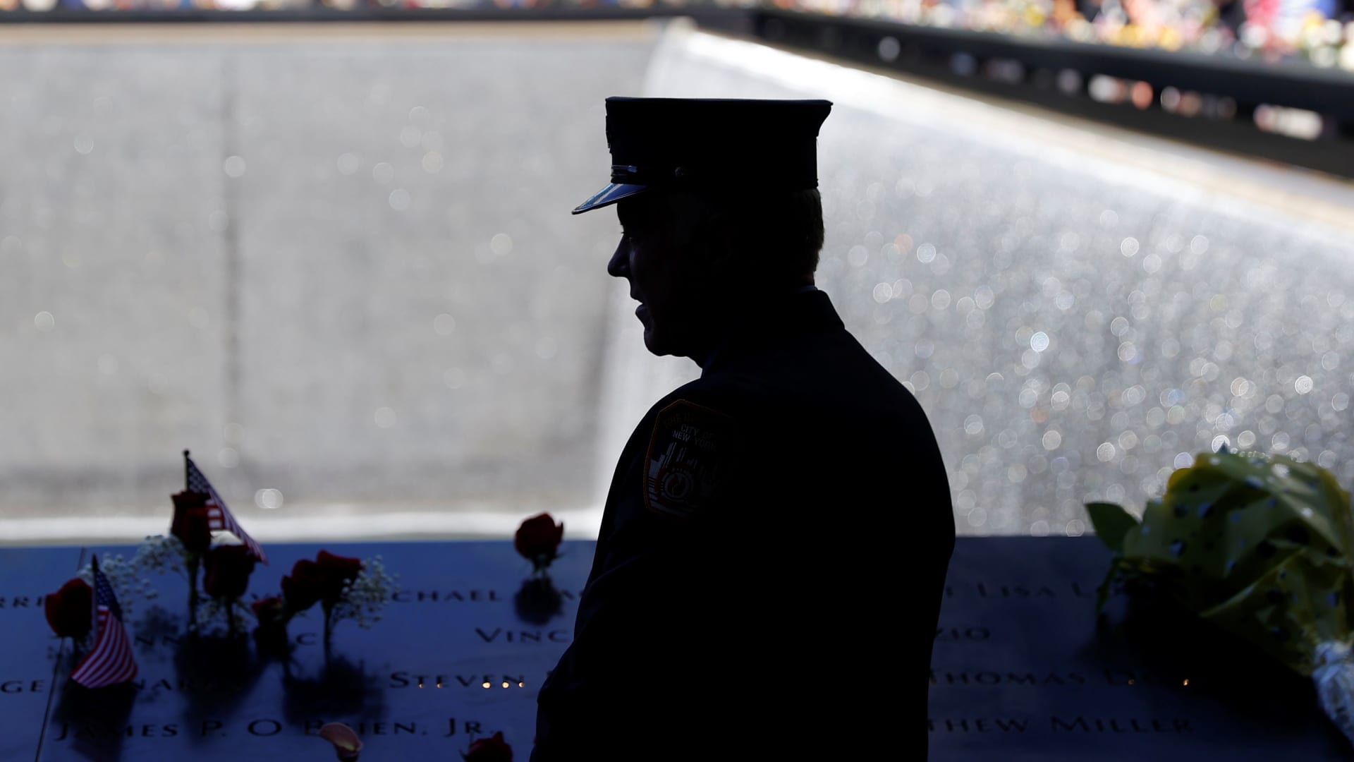 A member of the Fire Department of New York (FDNY) stands by the north reflecting pool at the 9/11 Memorial on the 20th anniversary of the September 11 attacks in Manhattan, New York City, U.S., September 11, 2021.