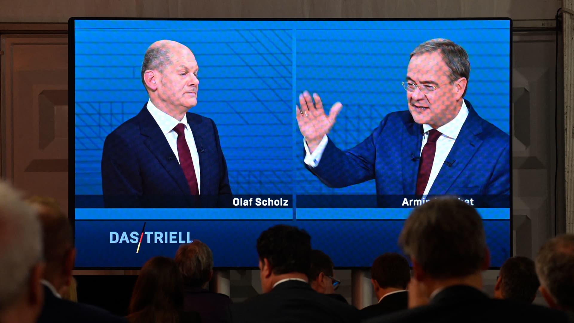 Journalists and party members watch on a screen from the press centre (L-R) Olaf Scholz, German Finance Minister, Vice-Chancellor and the Social Democrats (SPD) candidate for Chancellor and Armin Laschet, North Rhine-Westphalia's State Premier and the Christian Democratic Union (CDU) candidate for Chancellor as they attend an election TV debate in Berlin on September 12.