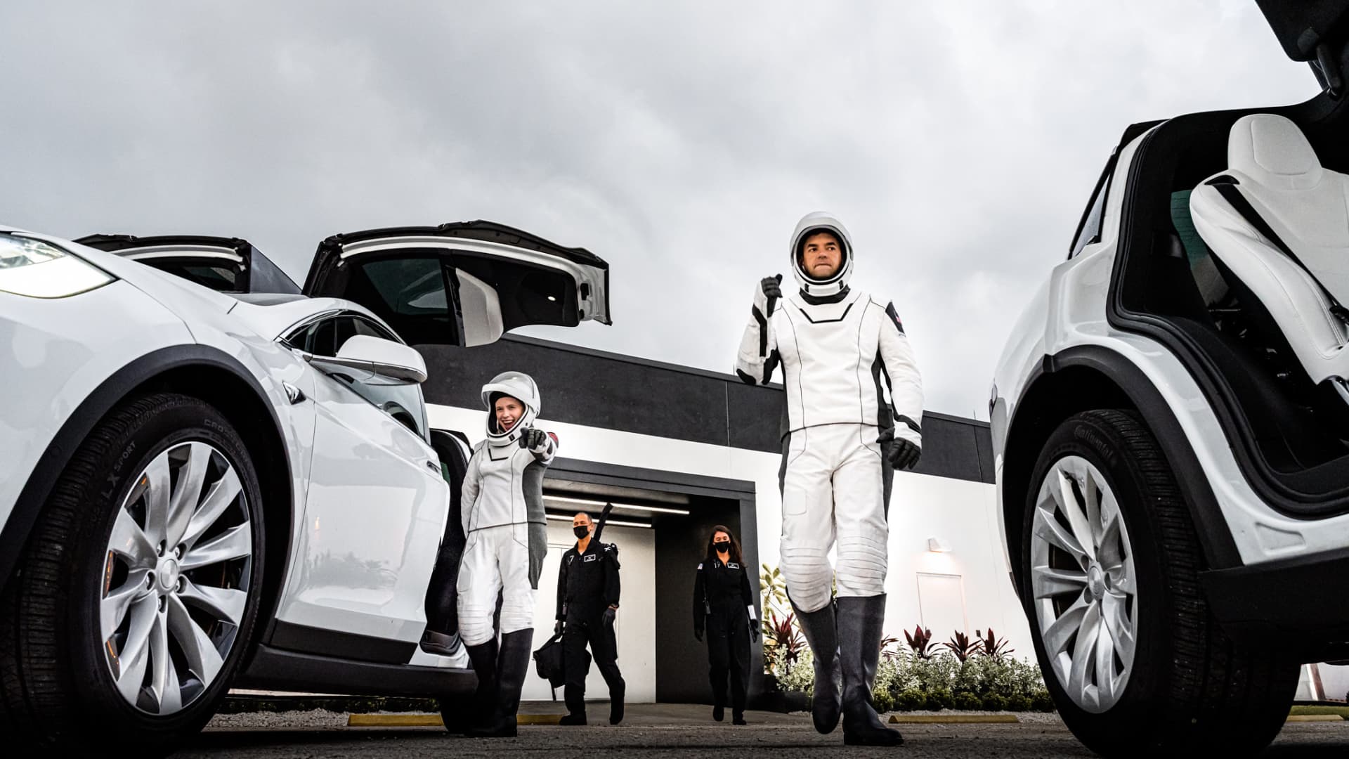 Hayley Arceneaux, left, and Jared Isaacman walk out and board the Tesla Model Xs that will take them to the launchpad during a launch rehearsal on September 12, 2021.