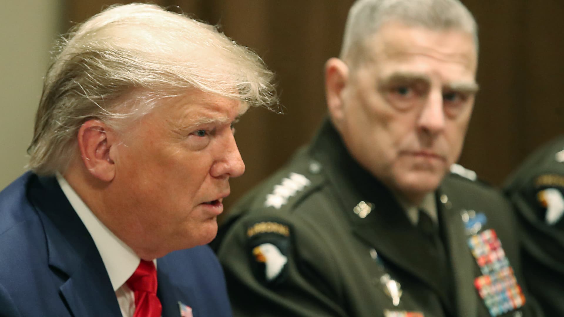 President Donald Trump speaks as Joint Chiefs of Staff Chairman, Army Gen. Mark Milley looks on after getting a briefing from senior military leaders in the Cabinet Room at the White House on October 7, 2019 in Washington, DC.