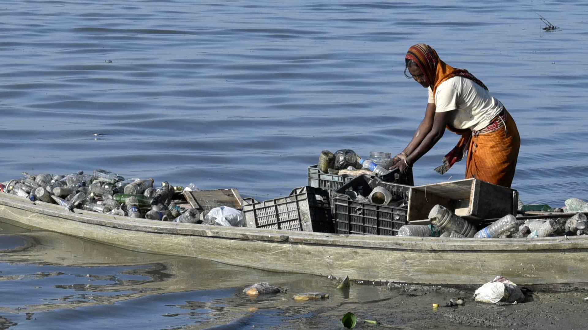 A women rag picker collecting plastic bottle and other plastic materials in a boat from the bank of Brahmaputra River in Guwahati, Assam, India on Monday, October 29, 2018.