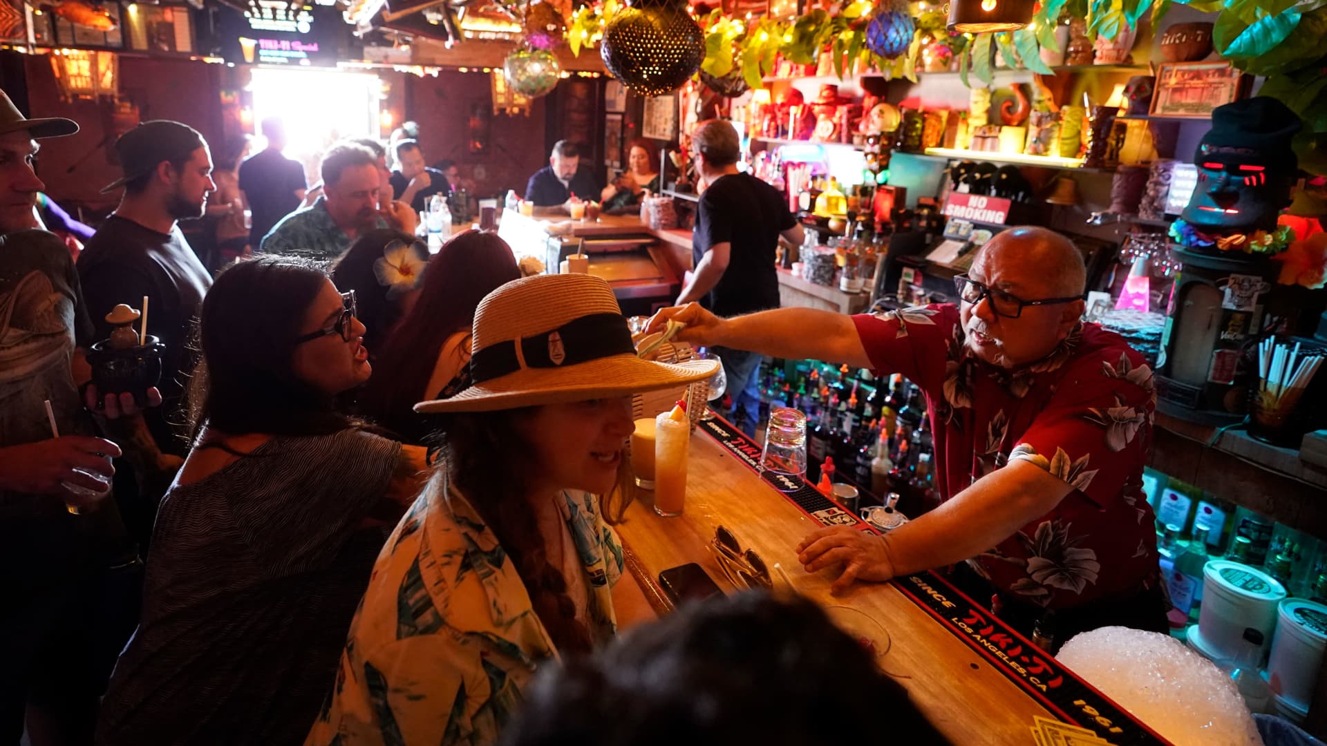 Patrons enjoy cocktails in the interior of the Tiki-Ti bar in Los Angeles, California, July 7, 2021.