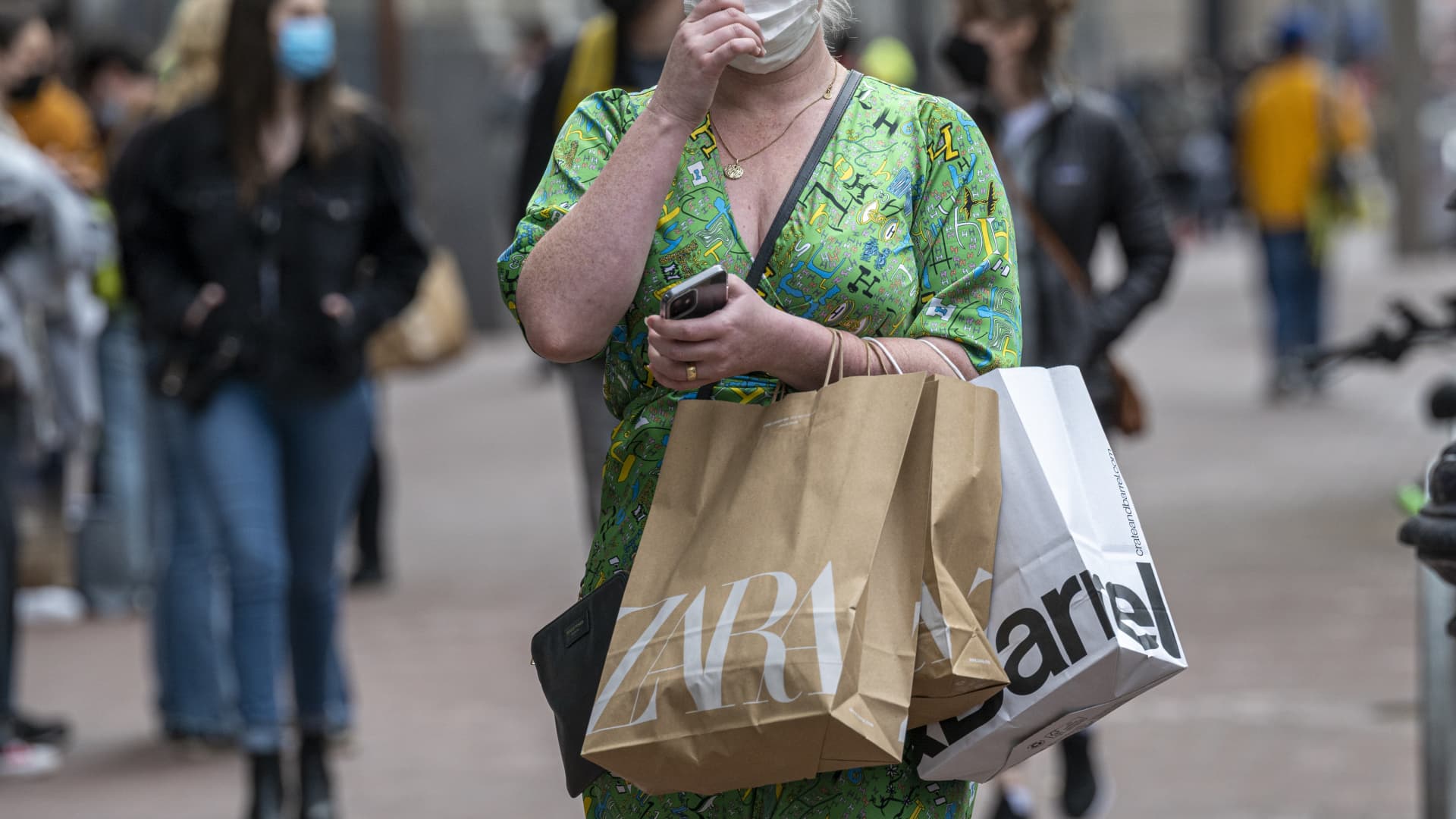 A pedestrian carries Zara shopping bags in San Francisco, California, U.S., on Thursday, Sept. 16, 2021.