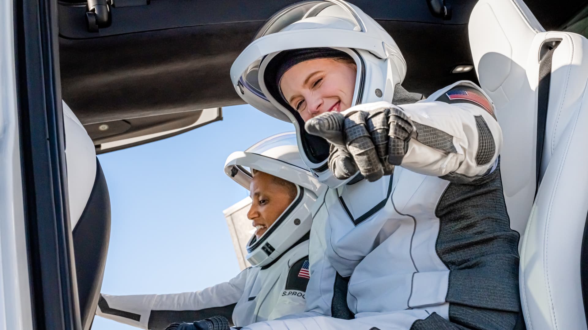 Medical officer Hayley Arceneaux points to the camera as she and pilot Sian Proctor board the Tesla Model X after suiting up before the launch on September 15, 2021.