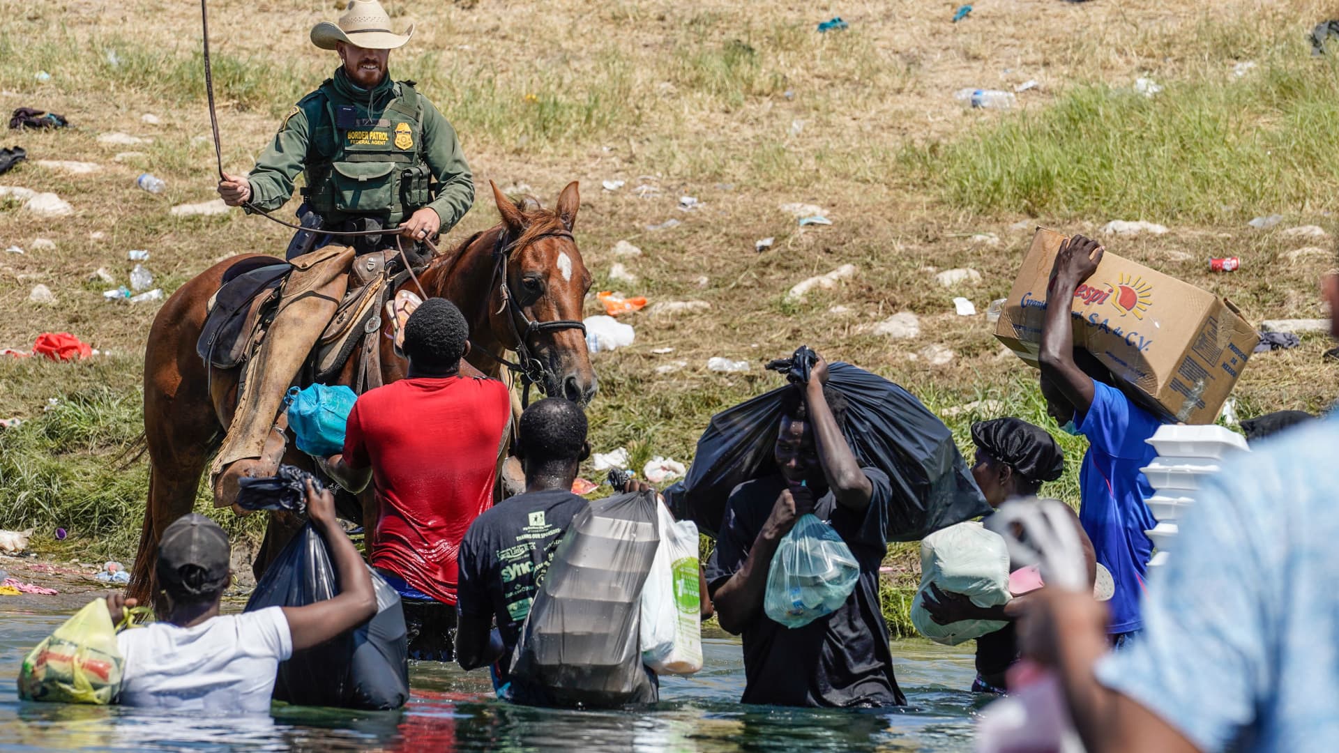 A United States Border Patrol agent on horseback uses the reins as he tries to stop Haitian migrants from entering an encampment on the banks of the Rio Grande near the Acuna Del Rio International Bridge in Del Rio, Texas on September 19, 2021.