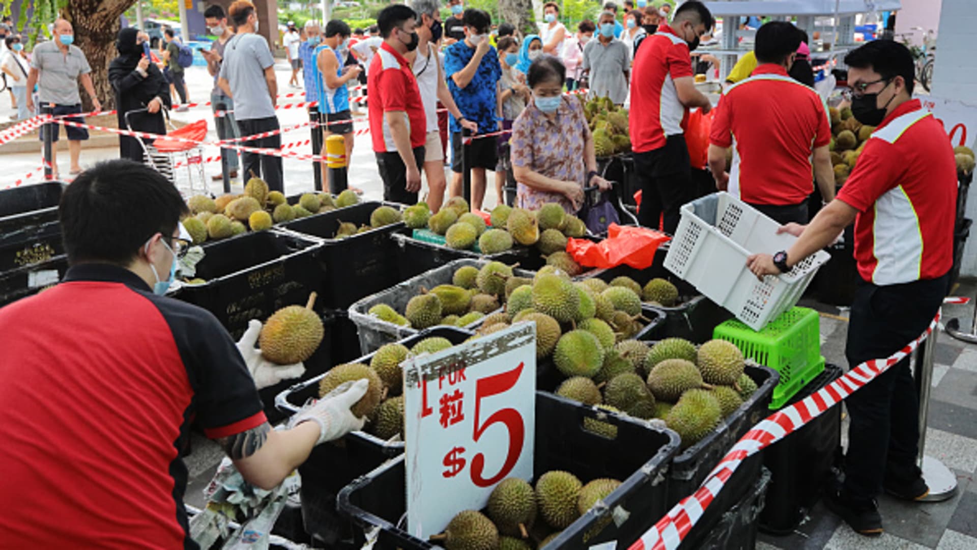 People wait in line to buy durians in Singapore on June 24, 2021.