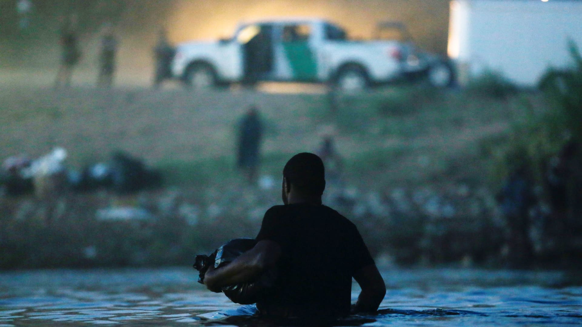 A migrant seeking refuge in the U.S. wades through the Rio Grande river from Ciudad Acuna, Mexico toward Del Rio, Texas, U.S. after getting supplies, in Ciudad Acuna, Mexico September 22, 2021.