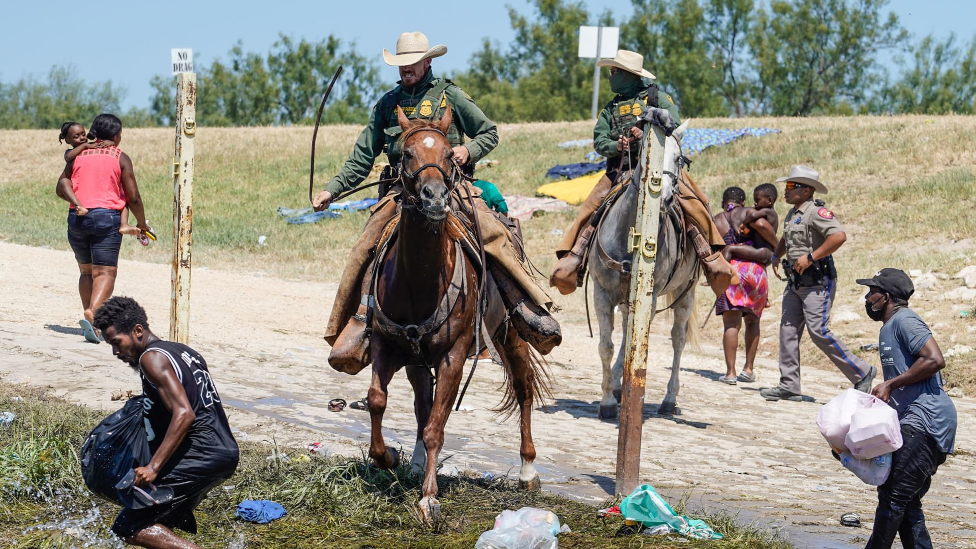 United States Border Patrol agents on horseback try to stop Haitian migrants from entering an encampment on the banks of the Rio Grande near the Acuna Del Rio International Bridge in Del Rio, Texas on September 19, 2021.