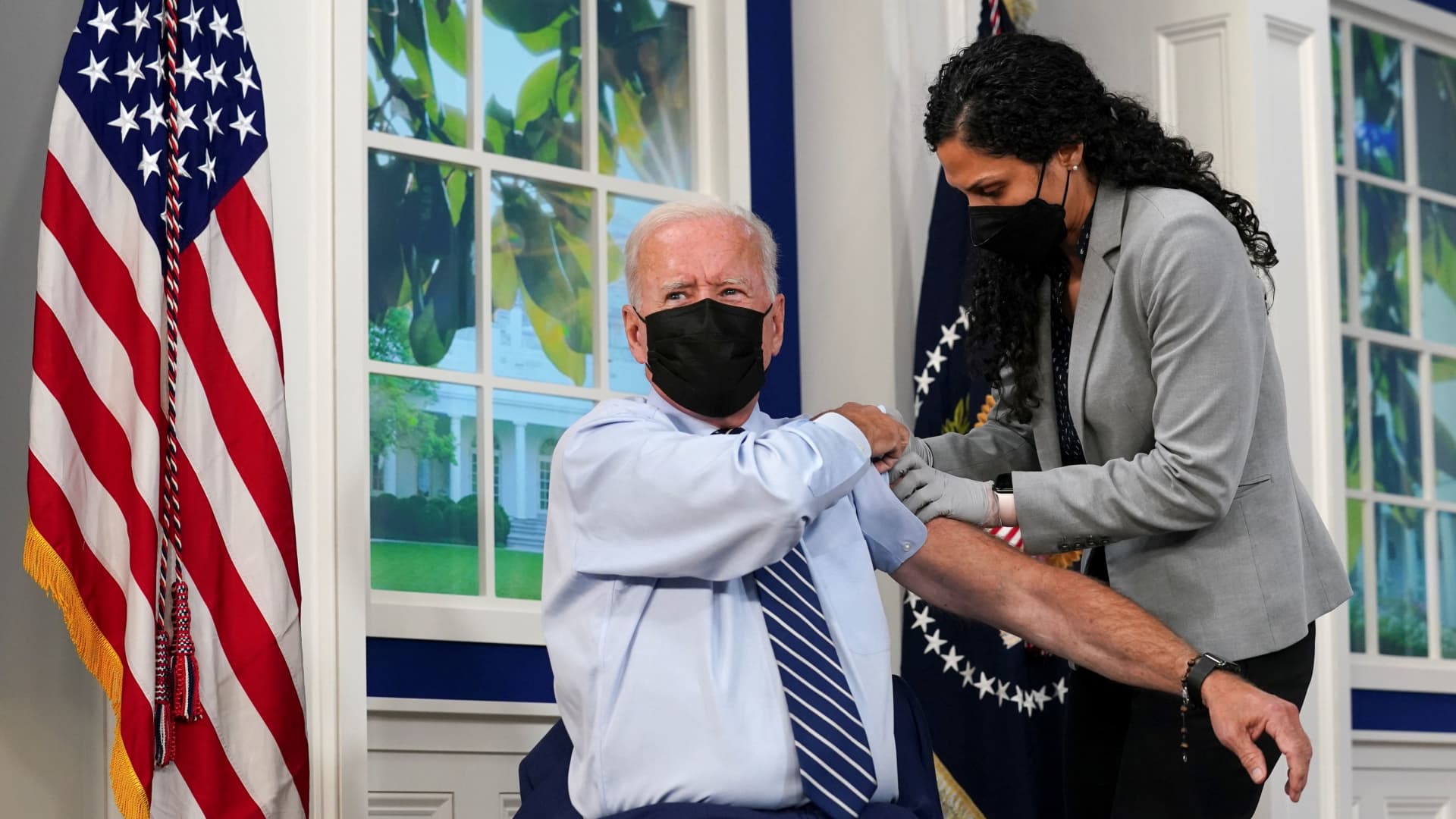 U.S. President Joe Biden holds up his sleeve to receive his coronavirus disease (COVID-19) booster vaccination in the Eisenhower Executive Office Building's South Court Auditorium at the White House in Washington, September 27, 2021.