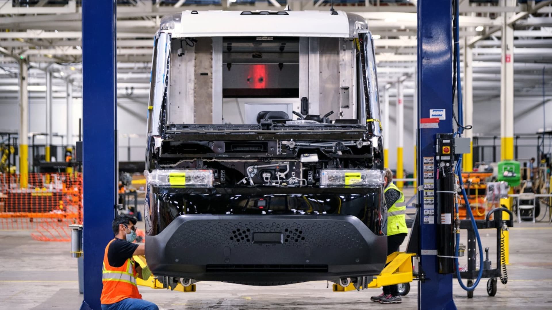 General Motors employee Anshul Shah attaches trim pieces onto the BrightDrop EV600, the company's first all-electric light commercial vehicle purpose-built for the delivery of goods and services on Sept. 24, 2021 in Livonia, Michigan.