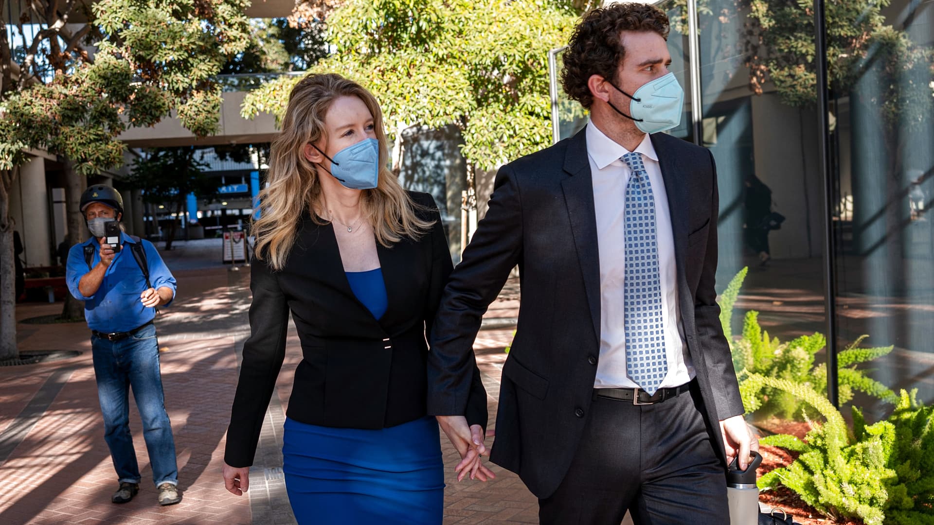 Elizabeth Holmes, founder of Theranos Inc., and husband Billy Evans leave federal court in San Jose, California, on Wednesday, Sept. 22, 2021.