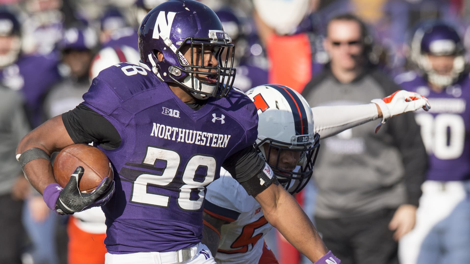 November 29, 2014: Illinois' T.J. Neil Jr. (52) attempts to tackle Northwestern's Justin Jackson (28) during the game between Northwestern University and the University of Illinois at Ryan Field in Evanston, Illinois.