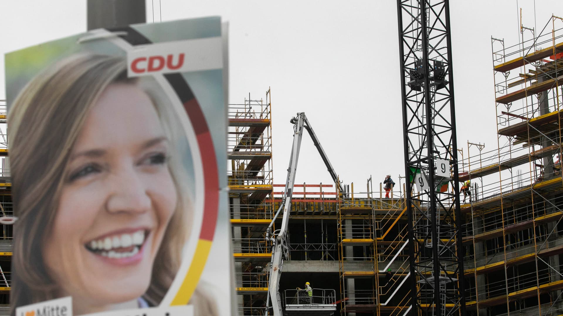 A national election poster for the Christian Democratic Union (CDU) party near a residential apartments construction site in the Mitte district of Berlin in 2021. After years of poor levels of investment in public infrastructure, there's a broad consensus among all political parties that more will be needed in the coming decade.