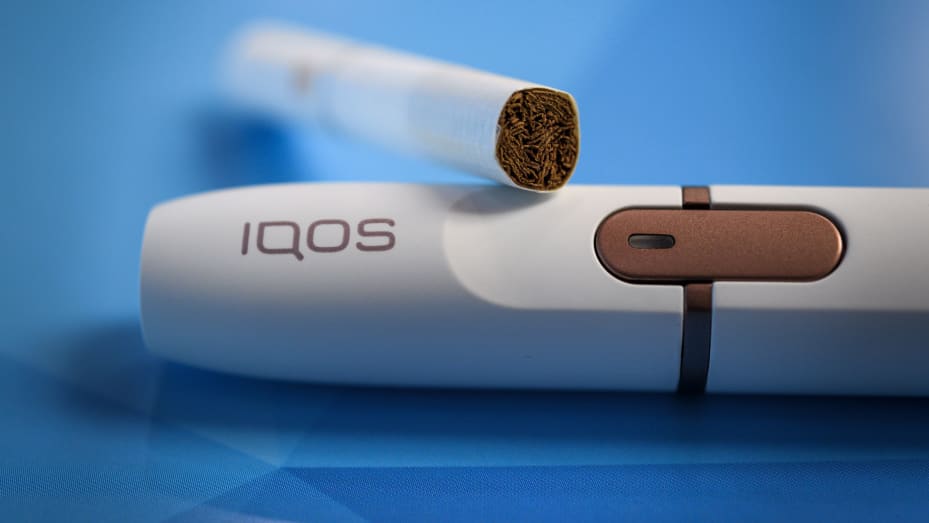 Philip Morris International shows an iQOS electronic cigarette, which heats tobacco sticks but does not burn them.