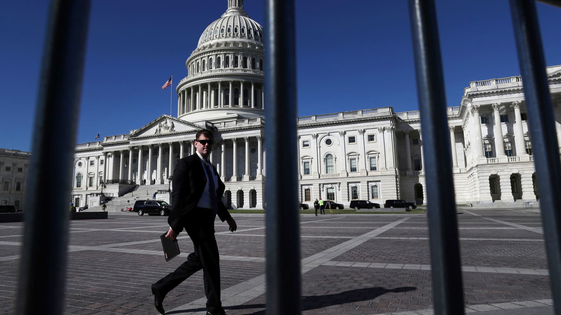 A man walks past the U.S. Capitol building as a government shutdown looms in Washington, September 30, 2021.
