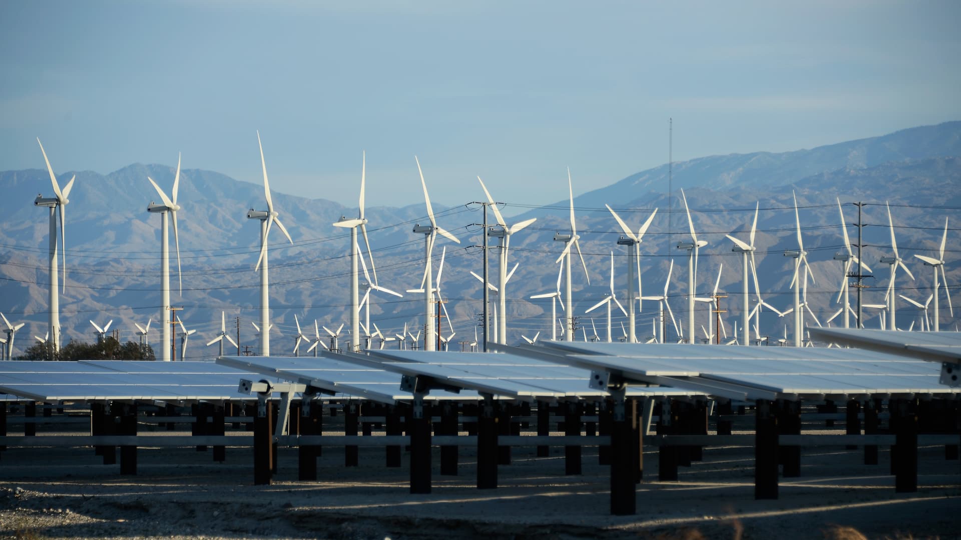 PALM SPRINGS, CA - MARCH 27:Giant wind turbines are powered by strong winds in front of solar panels on March 27, 2013 in Palm Springs, California. According to reports, California continues to lead the nation in green technology and has the lowest greenhouse gas emissions per capita, even with a growing economy and population.(Photo by Kevork Djansezian/Getty Images)