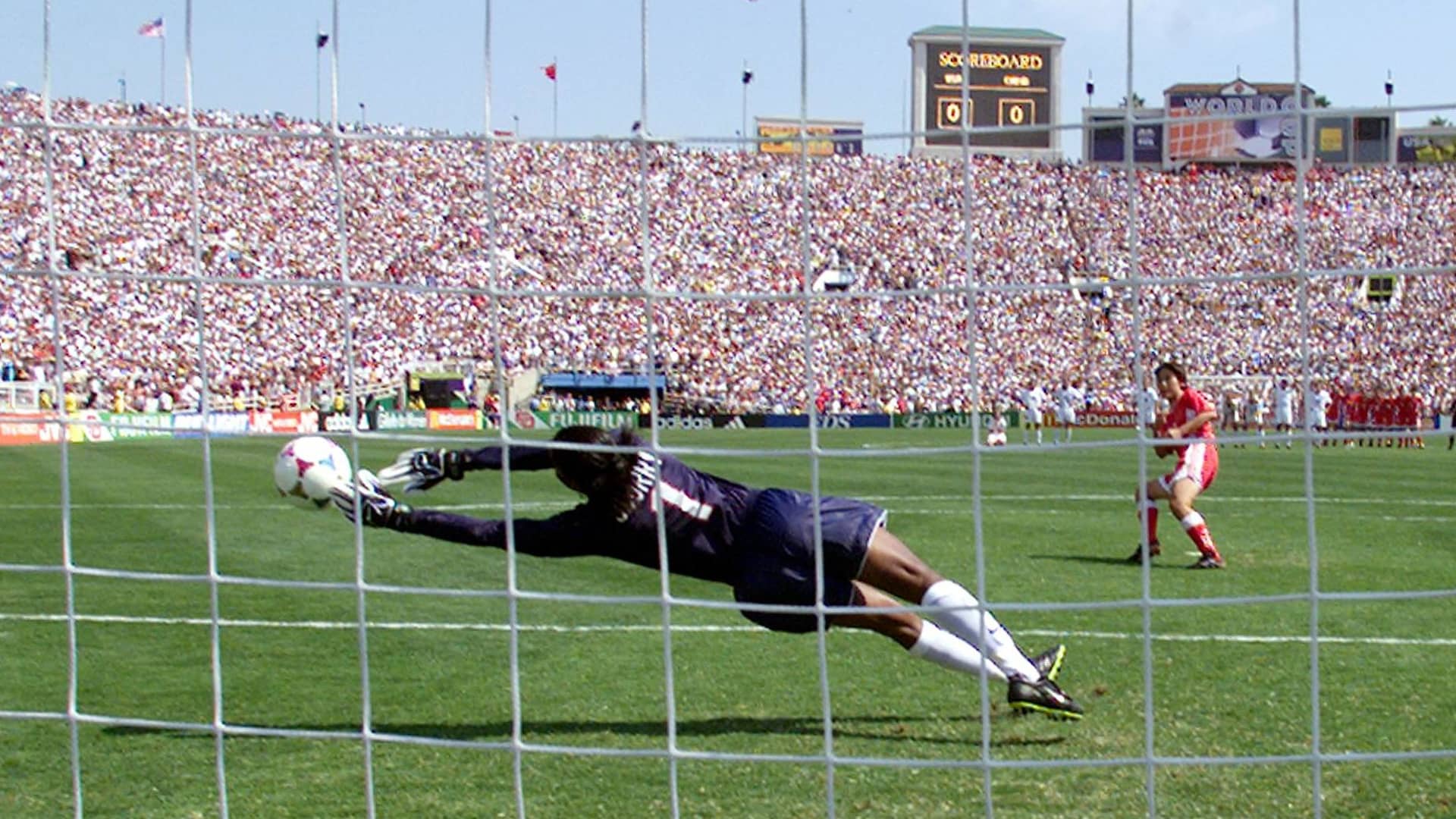 US goalkeeper Briana Scurry lunges as she stops the penalty kick by Liu Ying of the Chinese soccer team in a shoot-out at the end of their game in the finals of the Women's World Cup at the Rose Bowl in Pasadena, California 10 July 1999. The US team scored all of their five penalty shots to win the game.