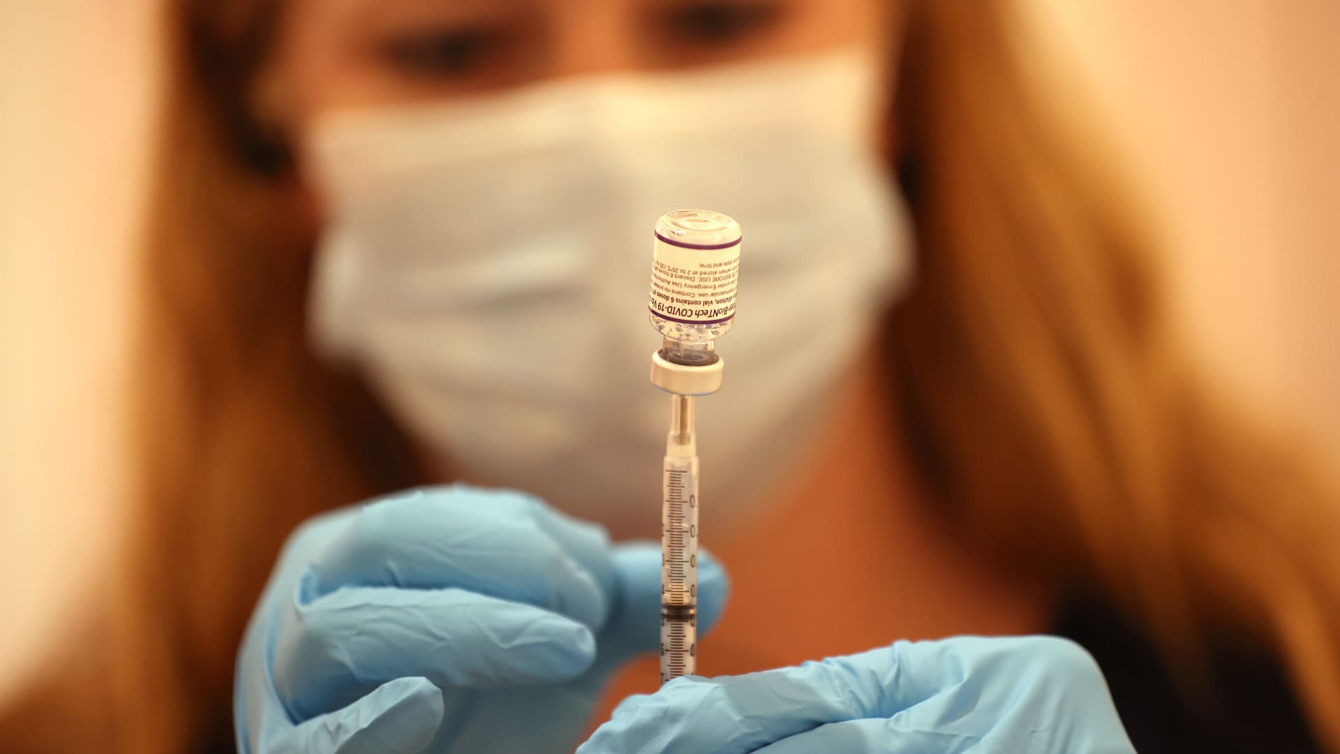 Safeway pharmacist Ashley McGee fills a syringe with the Pfizer COVID-19 booster vaccination at a vaccination booster shot clinic on October 01, 2021 in San Rafael, California.