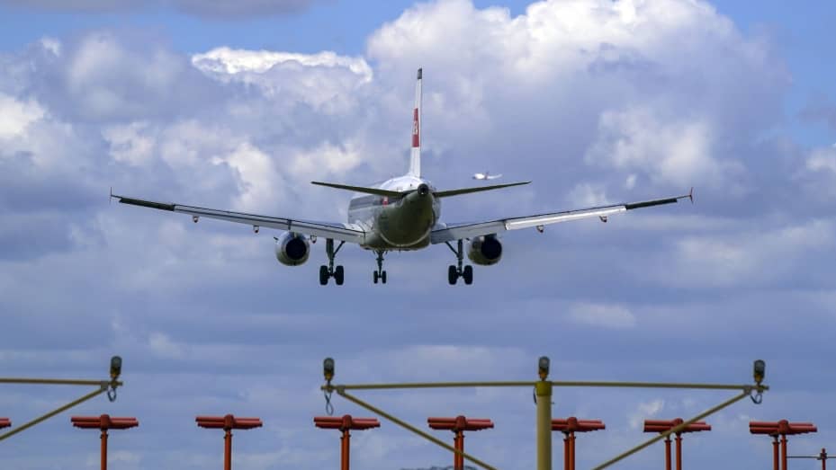 A plane lands on the southern runway at London Heathrow Airport. US and EU travellers who are fully vaccinated against coronavirus will be allowed to enter England and Scotland without the need to quarantine from Monday.