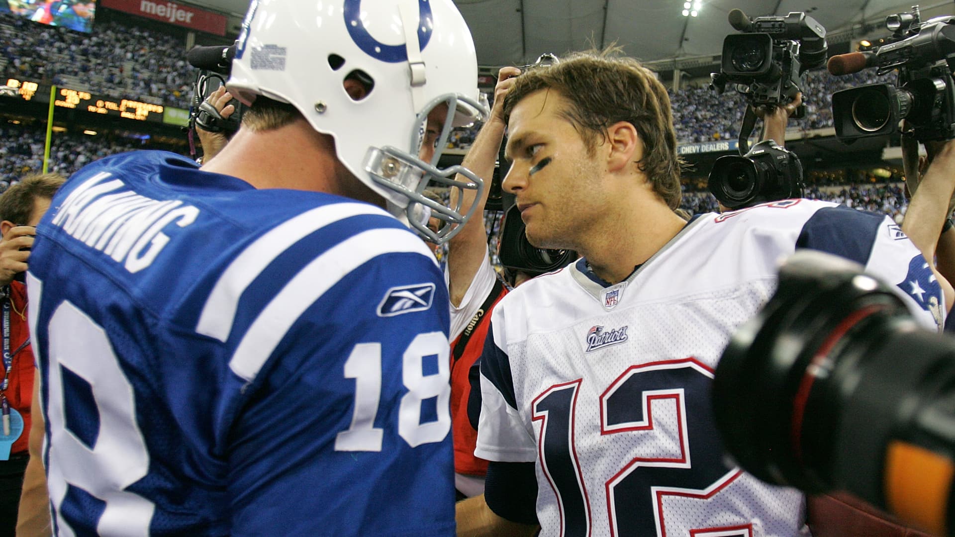 Peyton Manning #18 of the Indianapolis Colts and Tom Brady #12 of the New England Patriots meets on the field after the Patriots won their game 24-20 on November 4, 2007 at the RCA Dome in Indianapolis, Indiana.