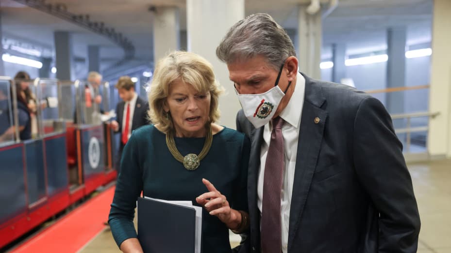 U.S. Senator Joe Manchin (D-WV) listens to Sen. Lisa Murkowski (R-AK) as they walk together in the Senate subway at the U.S. Capitol in Washington, U.S., October 6, 2021.
