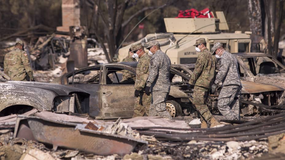 Troops from three California National Guard companies search through a fire-devastated neighborhood on October 14, 2017 in Santa Rosa, California.