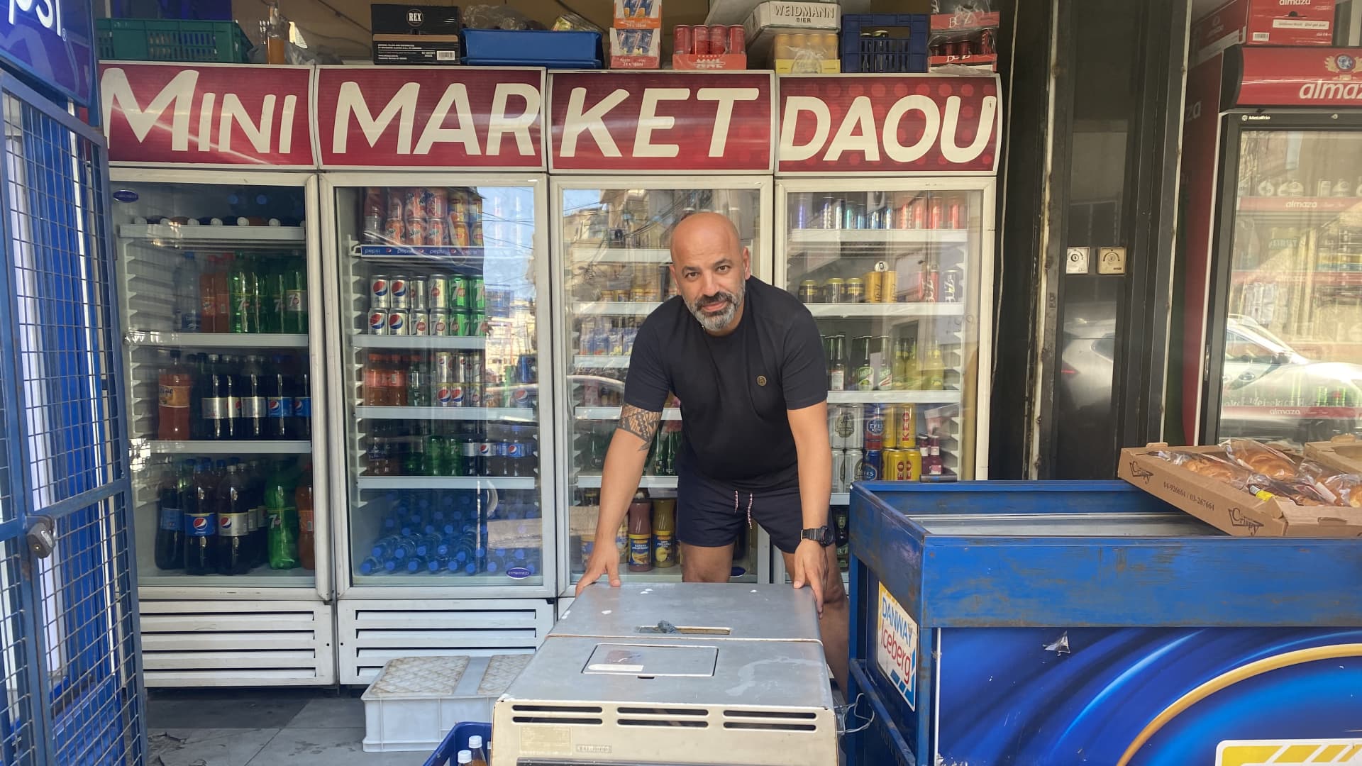 Rabih Daou, a shop owner in Beirut's Geitawy district, stands over his generator, the only means of electricity during hours-long daily power outages across Lebanon. The country's fuel crisis has made it harder to access fuel to run the generators. Beirut, Lebanon, September 24, 2021.