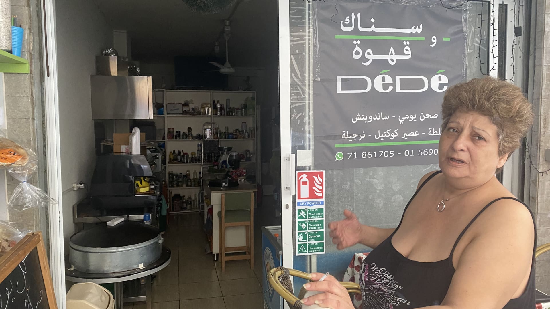 Dede Al Hayek stands in from of her darkened snack shop in Beirut's Geitawy district, which she had to close due to Lebanon's financial and fuel crisis. Beirut, Lebanon, September 25 2021.
