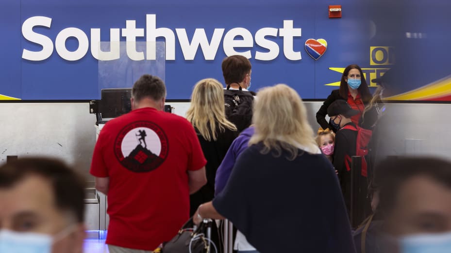 Travelers wait to check in at the Southwest Airlines ticketing counter at Baltimore Washington International Thurgood Marshall Airport on October 11, 2021 in Baltimore, Maryland.