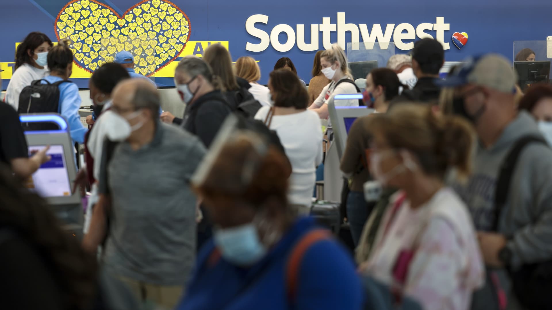Travelers wait to check in at the Southwest Airlines ticketing counter at Baltimore Washington International Thurgood Marshall Airport on October 11, 2021 in Baltimore, Maryland.