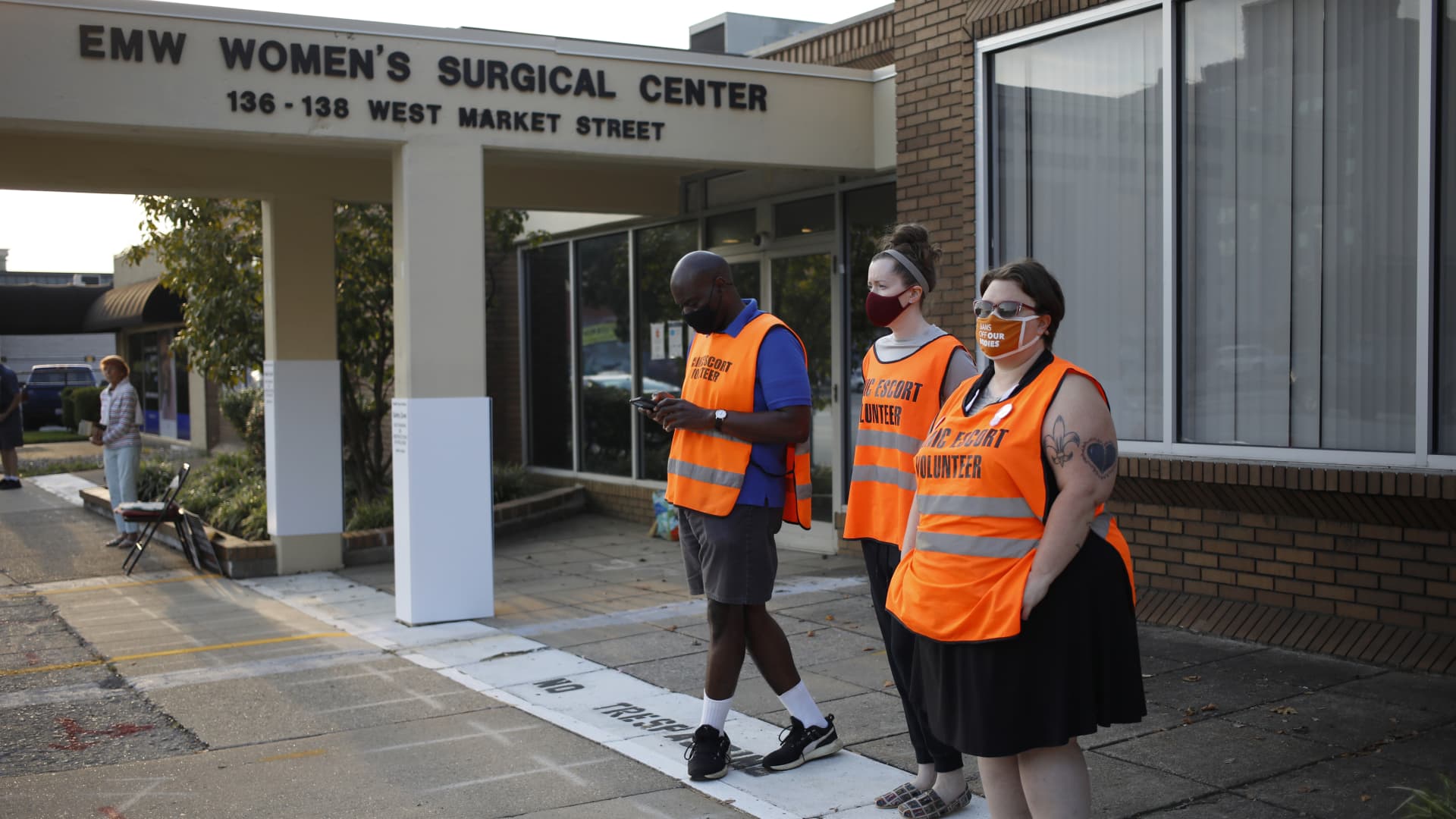 Volunteer clinic escorts wait for patients outside the EMW Women's Surgical Center in Louisville, Kentucky, U.S., on Tuesday, Sept. 28, 2021.
