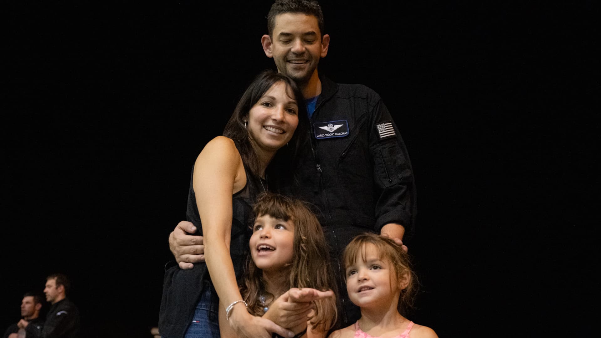 Isaacman reuniting with his wife, Monica, and their two daughters after splashdown.