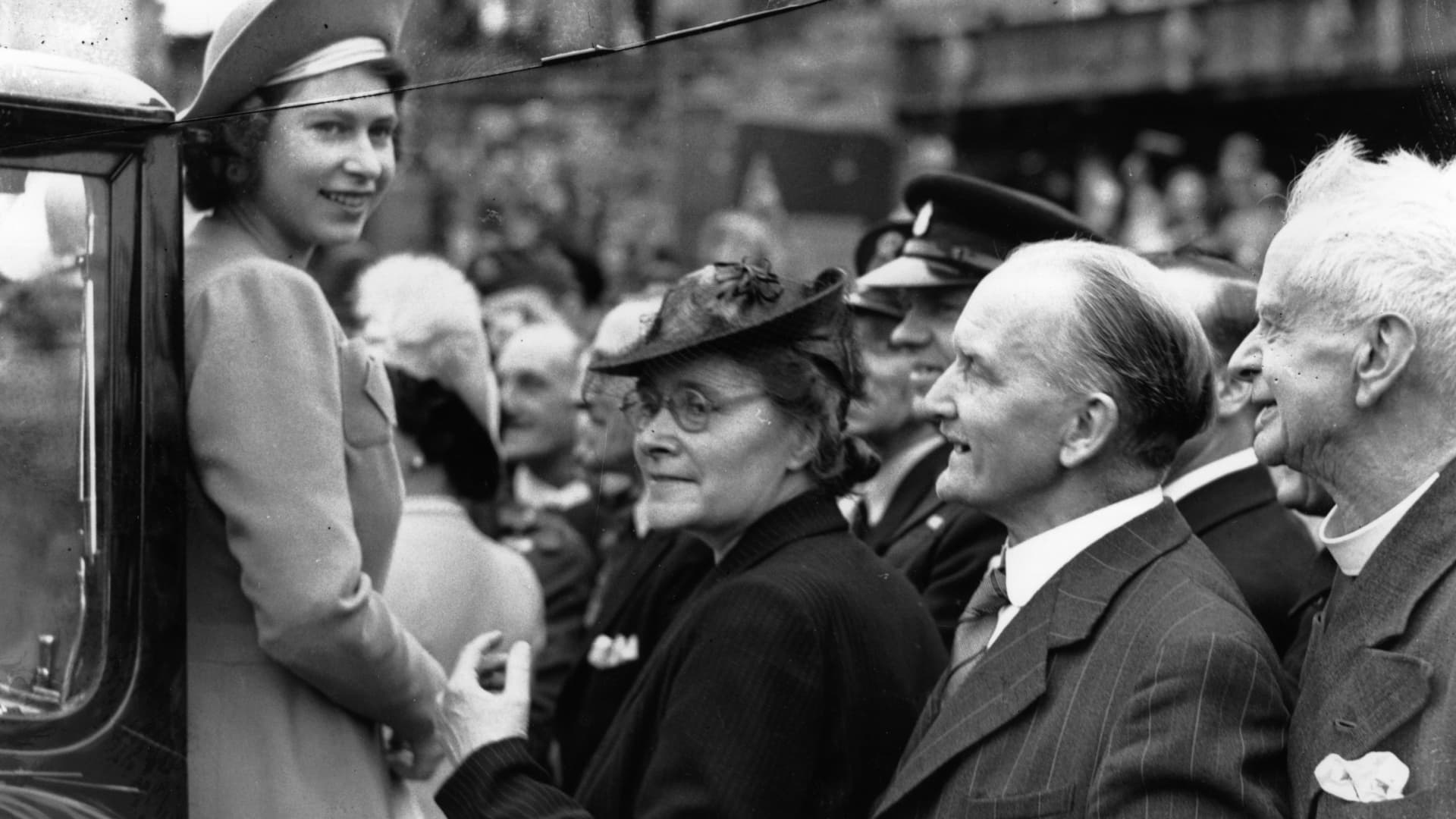 Princess Elizabeth (later Queen Elizabeth II) is greeted by crowds as she tours the East End of London on the day after VE Day, 9th May 1945.