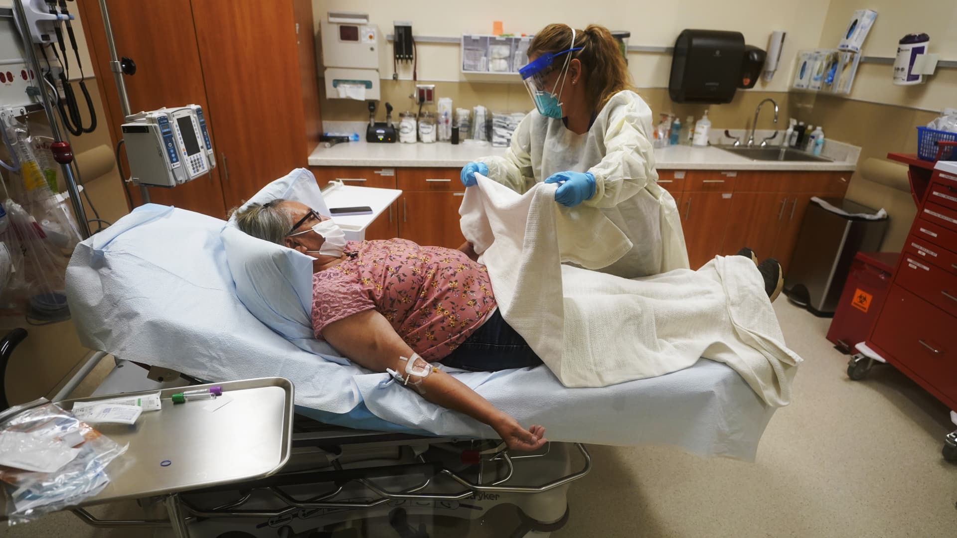 Angie Cleary, a registered nurse, cares for Joyce Johnson-Albert as she receives an antibody infusion while lying on a bed in a trauma room at the Upper Tanana Health Center Wednesday, Sept. 22, 2021, in Tok, Alaska.